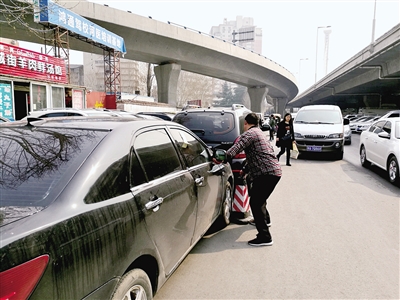 鄭州警方整治河醫(yī)橋下黑停車場(chǎng) 近百輛車被貼條